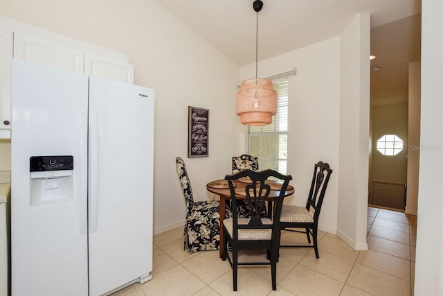 dining space with baseboards and light tile patterned floors