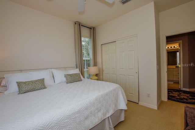 bedroom with light carpet, a ceiling fan, baseboards, and a closet