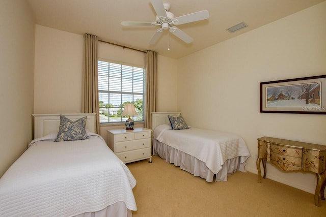 bedroom featuring light colored carpet, visible vents, and ceiling fan