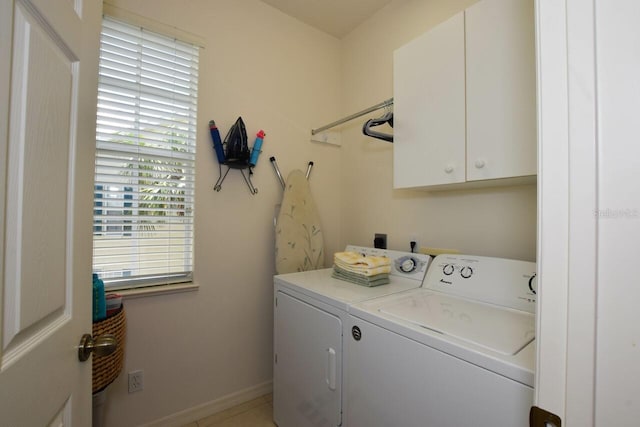 laundry room with washer and dryer, cabinet space, and baseboards