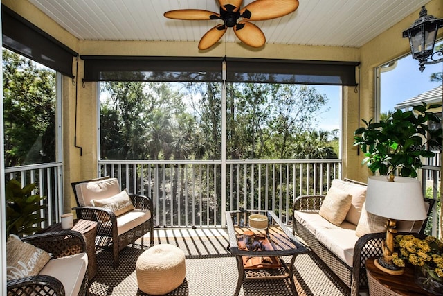 sunroom / solarium featuring ceiling fan