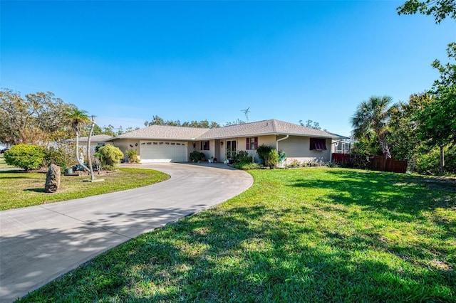 single story home with a garage, concrete driveway, fence, a front lawn, and stucco siding