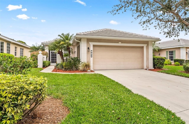 single story home featuring a garage, driveway, a tiled roof, stucco siding, and a front lawn