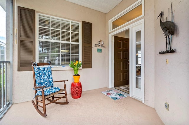 entrance to property with stucco siding