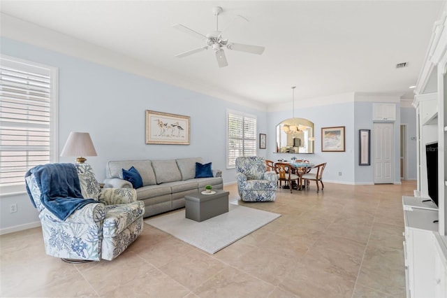 living room with baseboards, ornamental molding, visible vents, and a ceiling fan