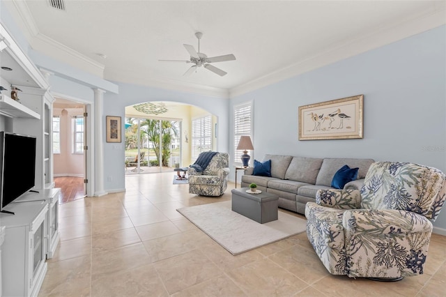 living room featuring light tile patterned floors, ornate columns, ornamental molding, ceiling fan, and baseboards