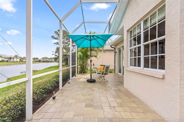 unfurnished sunroom featuring a water view