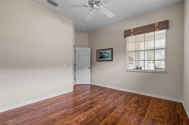 spare room with visible vents, ceiling fan, baseboards, and wood finished floors