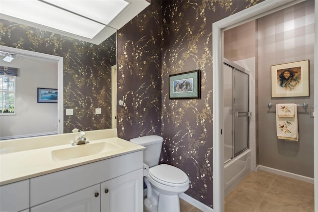 full bathroom featuring toilet, wallpapered walls, and vanity