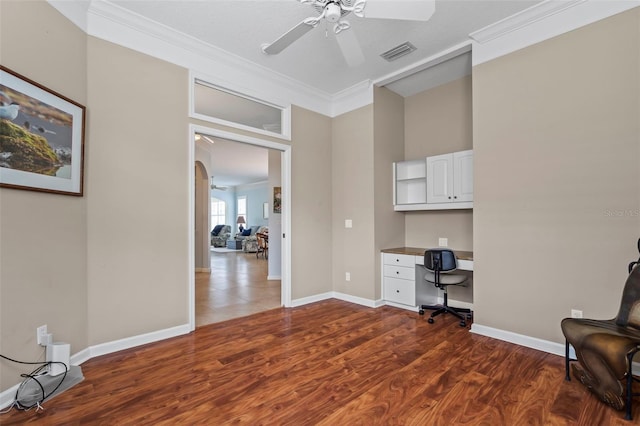 home office featuring visible vents, arched walkways, ceiling fan, ornamental molding, and dark wood-style flooring