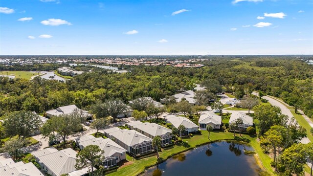 bird's eye view featuring a residential view, a water view, and a view of trees