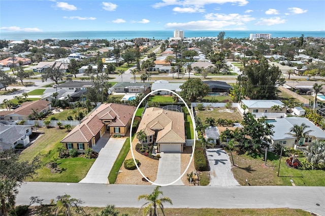 bird's eye view with a water view and a residential view