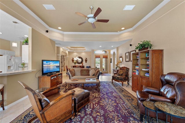 living area featuring a ceiling fan, visible vents, crown molding, and light tile patterned flooring