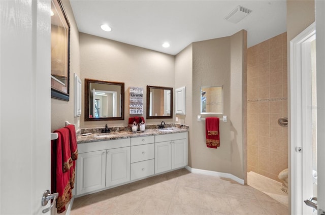 full bathroom with walk in shower, visible vents, a sink, and double vanity