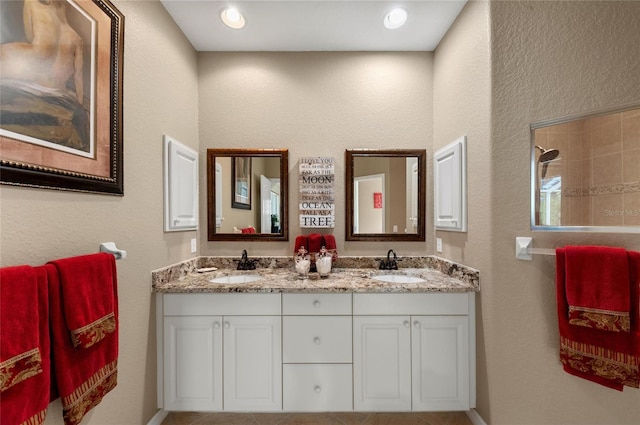 bathroom with a sink and double vanity