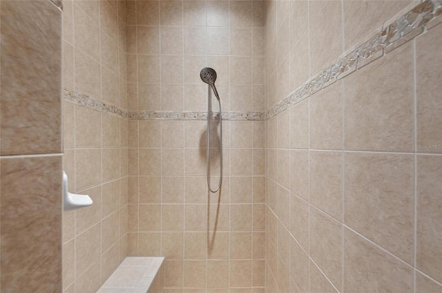 full bath with a tile shower