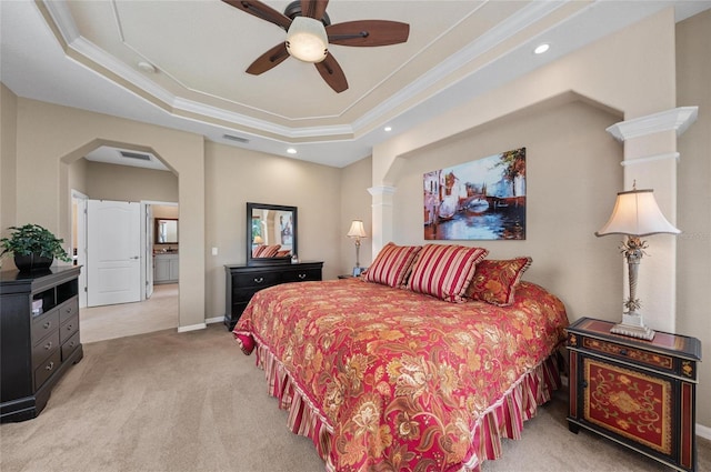 carpeted bedroom featuring ornamental molding, a tray ceiling, and visible vents