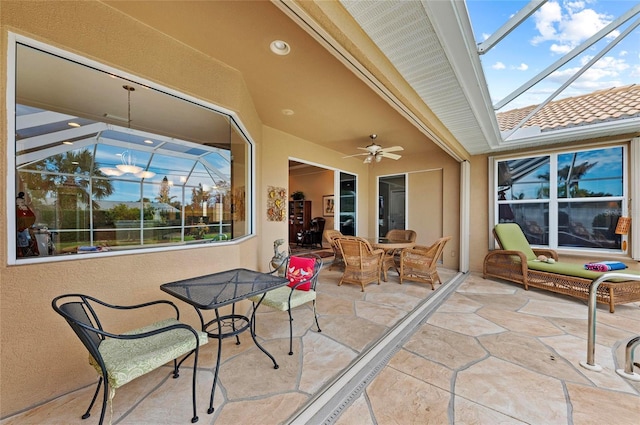 view of patio featuring ceiling fan and a lanai