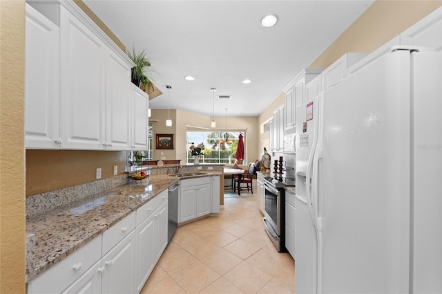 kitchen with stainless steel appliances, light tile patterned flooring, a peninsula, and white cabinetry