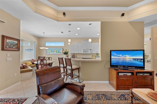 living room with light tile patterned floors, baseboards, and ornamental molding