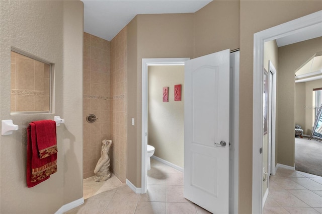 full bath with toilet, baseboards, walk in shower, and tile patterned floors