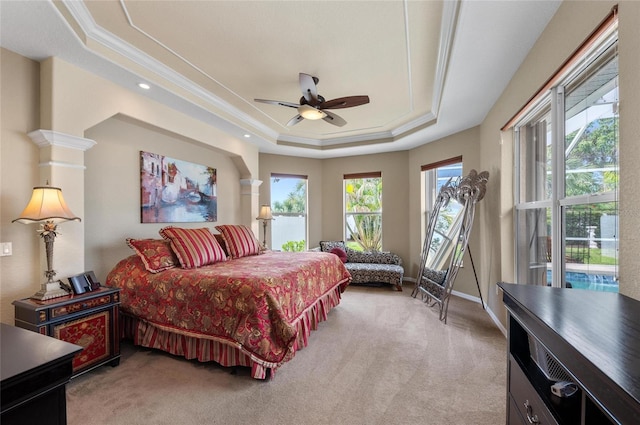 bedroom featuring a tray ceiling, crown molding, carpet flooring, ceiling fan, and baseboards