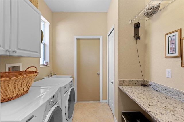 clothes washing area featuring cabinet space, separate washer and dryer, a sink, and light tile patterned flooring