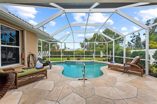 view of swimming pool featuring glass enclosure, a patio area, and a fenced in pool