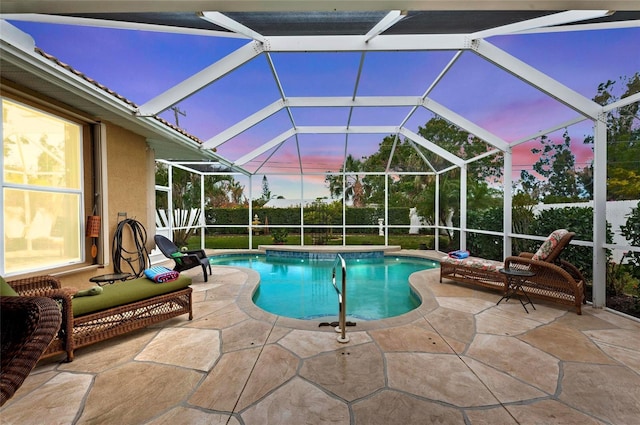 pool at dusk with a fenced in pool, a lanai, and a patio