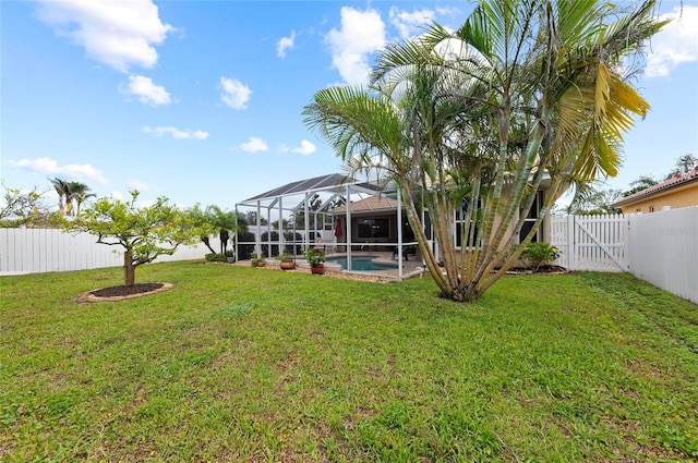 view of yard featuring a lanai, a fenced backyard, a gate, and a fenced in pool