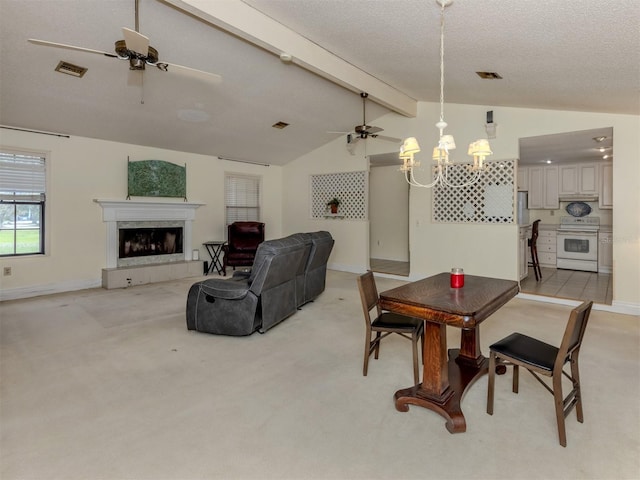 dining area featuring lofted ceiling with beams, visible vents, light carpet, and a fireplace with raised hearth