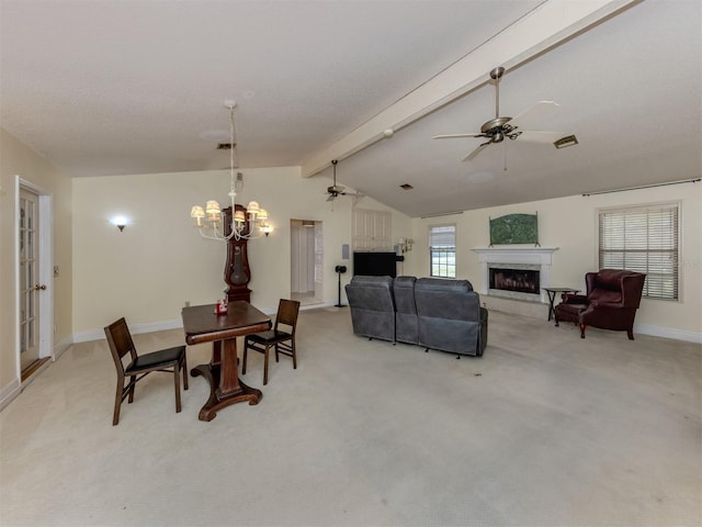 dining space with a fireplace with raised hearth, light colored carpet, ceiling fan with notable chandelier, and lofted ceiling with beams