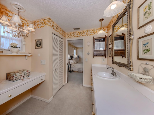 bathroom with vanity, baseboards, visible vents, an inviting chandelier, and a textured ceiling