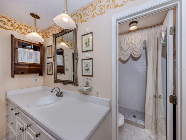 full bathroom featuring toilet, a textured ceiling, a shower stall, tile patterned flooring, and vanity