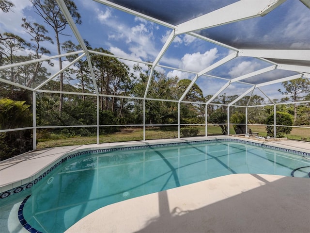 pool featuring glass enclosure and a patio