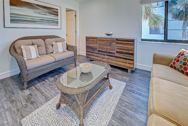 living area featuring baseboards and wood finished floors