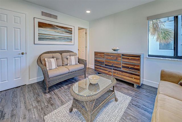 living area with recessed lighting, wood finished floors, visible vents, and baseboards