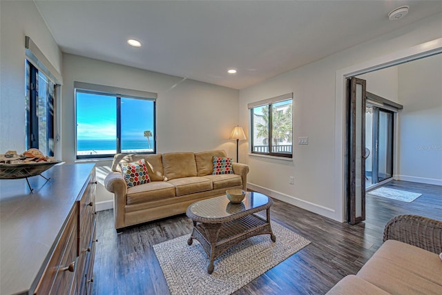 living room featuring baseboards, dark wood finished floors, and recessed lighting