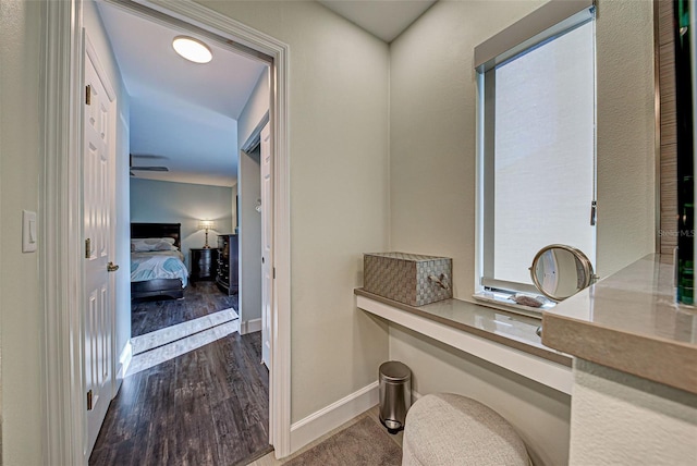 bathroom with baseboards and wood finished floors