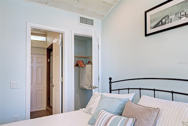 bedroom with a walk in closet, a closet, and visible vents