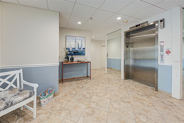 corridor featuring recessed lighting, a drop ceiling, and elevator