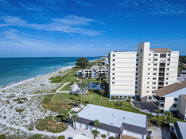 bird's eye view with a water view and a beach view