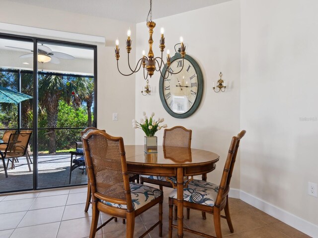 dining room with ceiling fan with notable chandelier, baseboards, and light tile patterned flooring