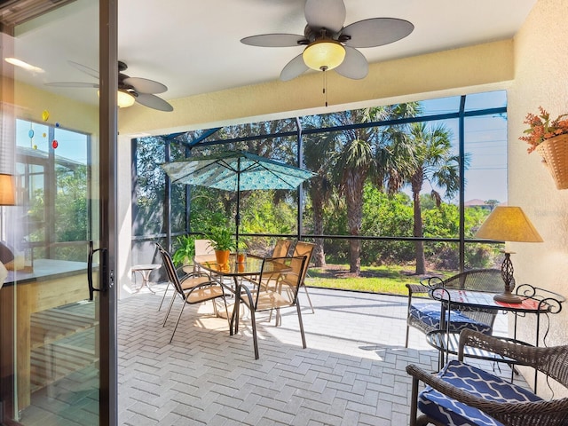 sunroom / solarium featuring ceiling fan