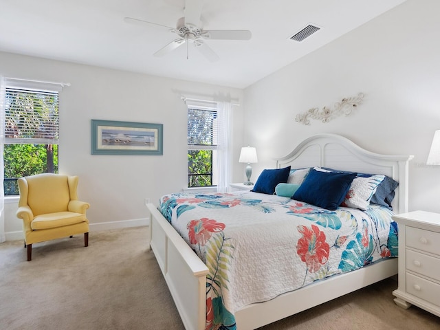 bedroom featuring multiple windows, carpet, visible vents, and baseboards