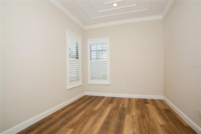 unfurnished room featuring ornamental molding, baseboards, and wood finished floors