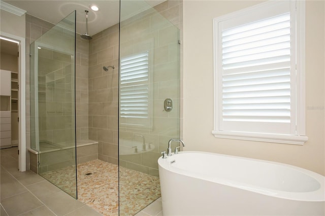 full bathroom with tile patterned flooring, a soaking tub, and tiled shower