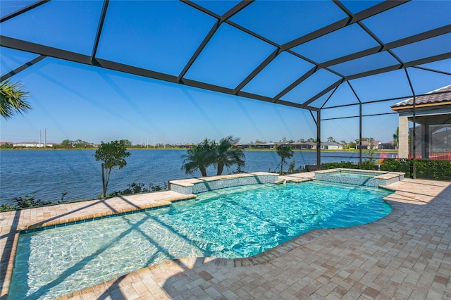 view of pool featuring a patio area, a lanai, a pool with connected hot tub, and a water view