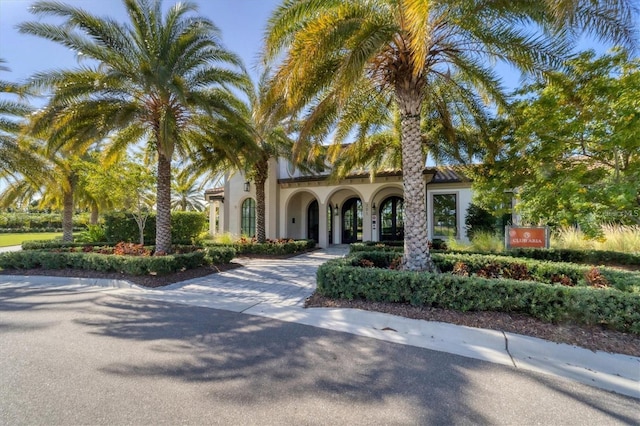 view of front facade with concrete driveway and stucco siding