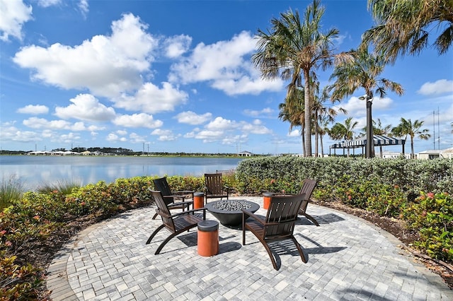 view of patio featuring a water view and an outdoor fire pit